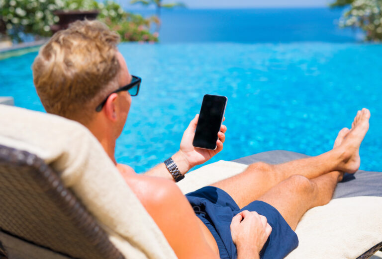 Man using phone by the pool